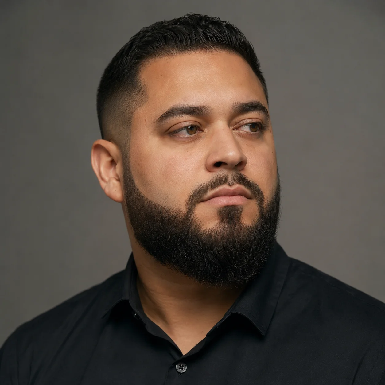 Man with a round face and a shaped medium full beard